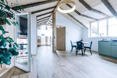 a dining room with a table and chairs in a building at Amplatz 1523 - B&B and Suites in Montagna