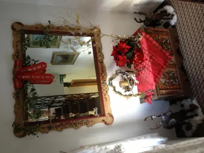 a mirror hanging on a wall with christmas decorations at Garni Sayonara in Selva di Val Gardena