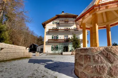 a large building with a gazebo in front of it at Apartments Waldquell in Collalbo