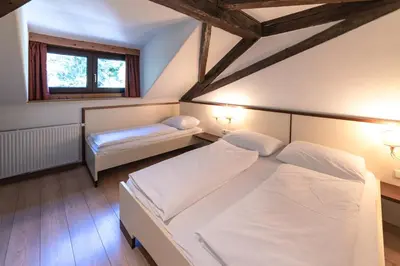 a bedroom with two white beds and a window at Apartments Waldquell in Collalbo