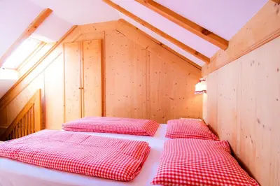 a bedroom with two beds in a wooden room at Residenz am Kaiserweg in Longomoso