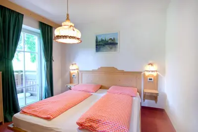 a bedroom with two beds and a window at Residenz am Kaiserweg in Longomoso