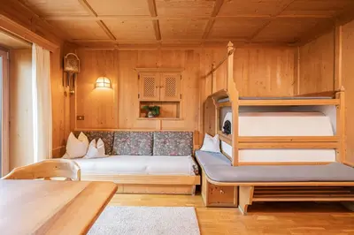 a bedroom with two beds and a bunk bed at Appartamenti Elbrus in Santa Cristina in Val Gardena