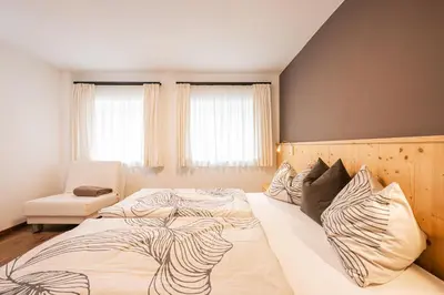 a bedroom with two large beds with pillows at Appartamenti Elbrus in Santa Cristina in Val Gardena