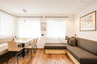 a living room with a couch and a table at Appartamenti Elbrus in Santa Cristina in Val Gardena