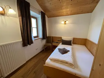 a small bedroom with a bed in a room at Gasthaus Bad Siess in Longomoso