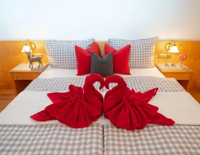 two hearts made out of red towels on a bed at Gasthaus Bad Siess in Longomoso