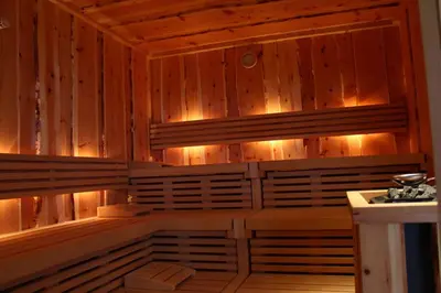 a sauna with wooden walls and lights in a room at Gasthaus Bad Siess in Longomoso