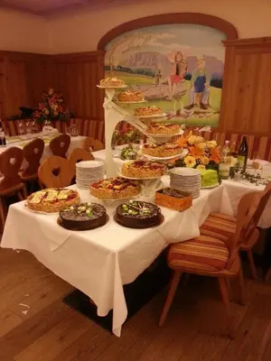 a long table with many plates of food on it at Gasthaus Bad Siess in Longomoso