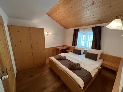 a bedroom with a large bed in a room at Gasthaus Bad Siess in Longomoso