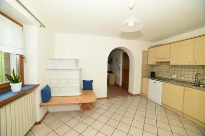 a kitchen with a table and a counter top at Cesa Mandi e Miky in Canazei