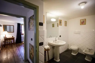 a bathroom with a sink and a toilet at LA PITA in La Valle