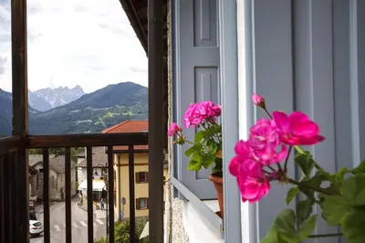 a window with pink flowers on a balcony at LA PITA in La Valle