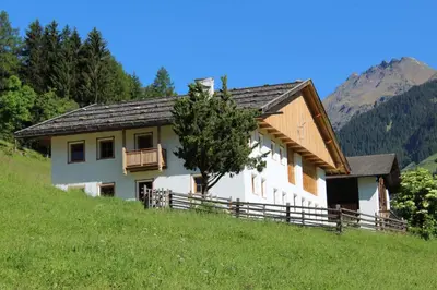 a house on a hill with a tree in front of it at Volggerhof in Racines
