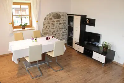 a dining room with a white table and a tv at Volggerhof in Racines