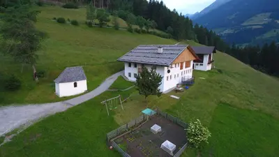 an aerial view of a house on a hill at Volggerhof in Racines