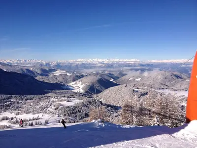 a skier on the top of a snow covered mountain at Hotel Patrizia Dolomites Glamour in Moena