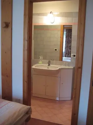 a bathroom with a sink and a mirror at B&B Ciasa Weber in Moena