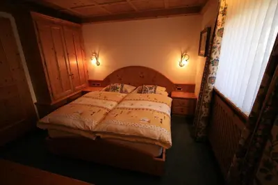 a bedroom with a large bed in a room at B&B Ciasa Weber in Moena