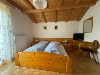 a bedroom with a large wooden bed in a room at Nature Residence Telfnerhof in Laion