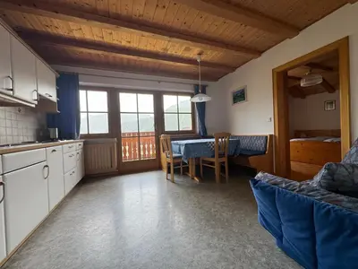 a kitchen and dining room with a table and chairs at Nature Residence Telfnerhof in Laion