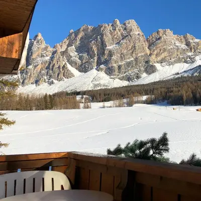 a view of a snow covered mountain from a balcony at Boutique Hotel Villa Blu Cortina D'Ampezzo in Cortina dʼAmpezzo
