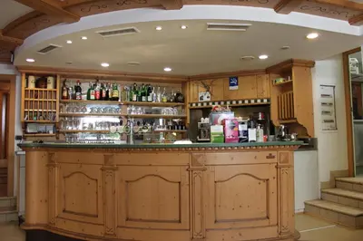 a bar in a room with a lot of alcohol at Albergo Hofer in Bolzano