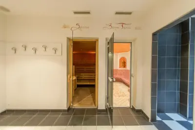 a hallway with a door leading to a bedroom at Hotel Italia in Castello di Fiemme