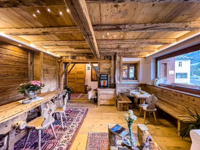 a room with wooden walls and tables and chairs at Hotel da Beppe Sello in Cortina dʼAmpezzo