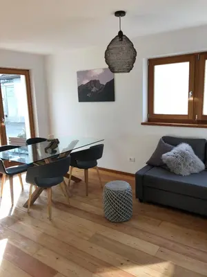a living room with a glass table and a couch at Apartment Himmelreich in Brunico