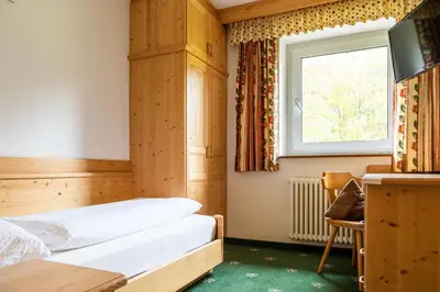 a bedroom with a bed and a window at Garni Juri in La Villa
