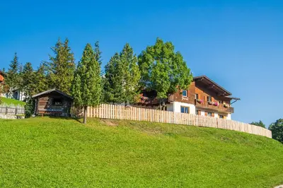 a house on top of a hill with a fence at Garni Juri in La Villa
