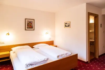 a hotel room with two beds in it at Garni Juri in La Villa