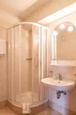 a bathroom with a shower and a sink at Garni Juri in La Villa