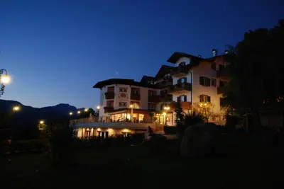a large building at night with the lights on at La Montanina Hotel in Val di Non in Malosco