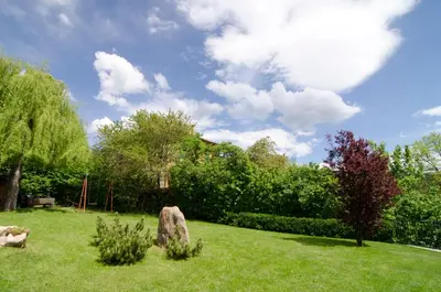 a garden with two rocks in the grass at La Montanina Hotel in Val di Non in Malosco