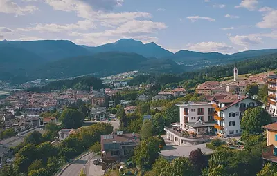 an aerial view of a town in the mountains at La Montanina Hotel in Val di Non in Malosco