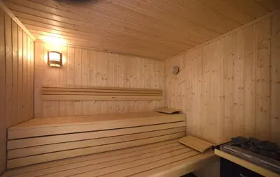 a wooden sauna with a wooden tub in it at Hotel Barance in Alleghe