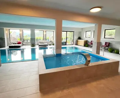 a large swimming pool in a house at Hotel Residence MaVie in Lagundo
