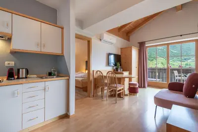 a kitchen with a living room and a bedroom at Hotel Residence MaVie in Lagundo