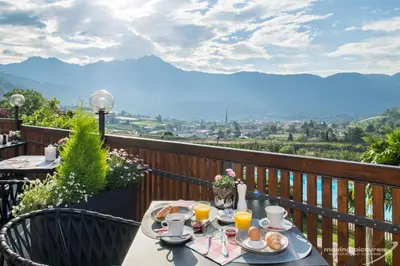 a table with food and drinks on a balcony at Hotel Residence MaVie in Lagundo