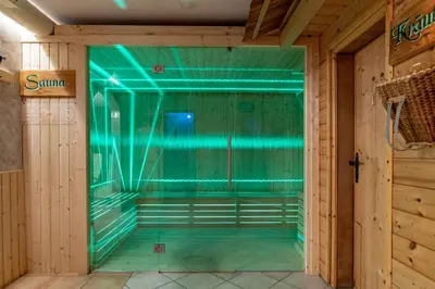 a room with green lights on the wall at Hotel Kronplatzer Hof in Rasun di Sopra