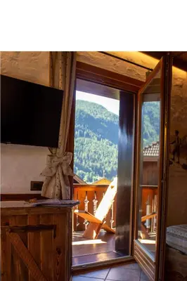 a room with a sliding glass door with a view of a mountain at Residence Lastè in Moena