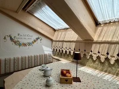 a room with a table with a bowl of fruit on it at Residence Lastè in Moena