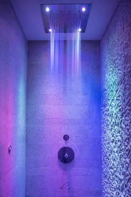 a room with purple and pink lights on a wall at Residence Lastè in Moena