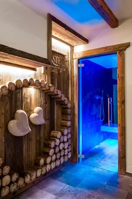 a room with a wooden wall with hats on it at Residence Lastè in Moena