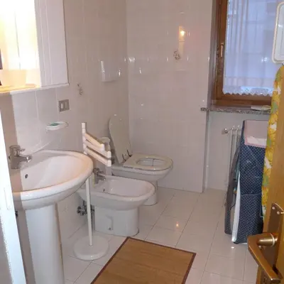 a bathroom with a toilet and a sink at Condominio La Mont 2 in Piaia