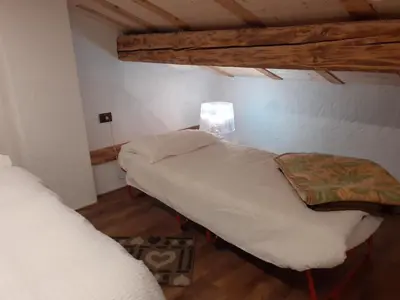 a room with two beds and a lamp in it at Casa Sicina in Sicina