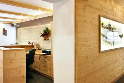 a kitchen with a wooden wall with a picture on it at B&B La Tranquillitè in Corvara in Badia