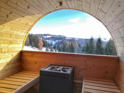 an arched window in a sauna with a view at Oberhauser Hütte Rodenecker - Lüsner Alm in Luson